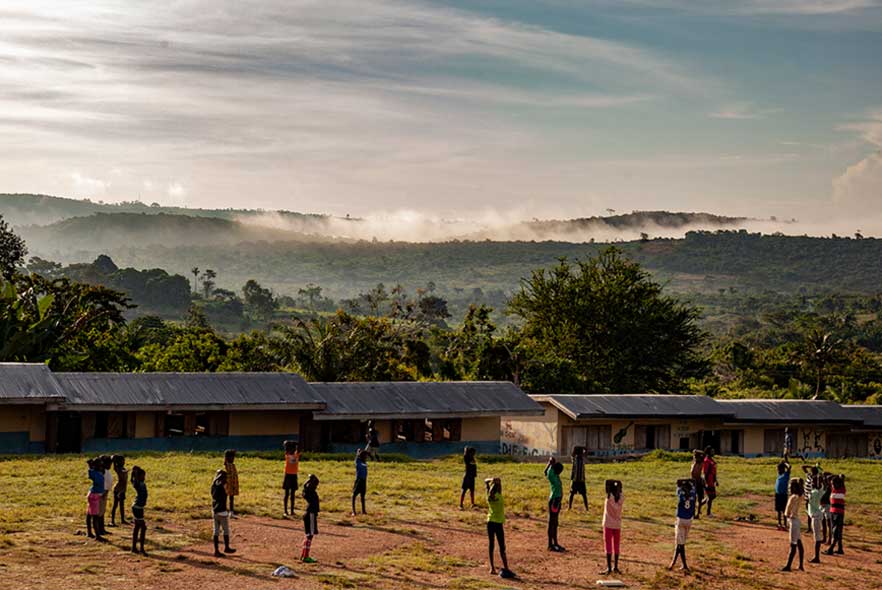 Children standing in a circle doing excercise in Ghana