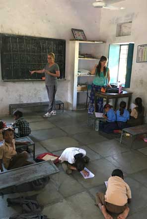 Volunteers teaching in a community school in Udaipur