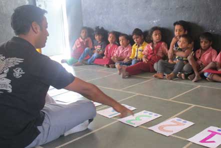 Ravi leading an educational activity at the day care centre