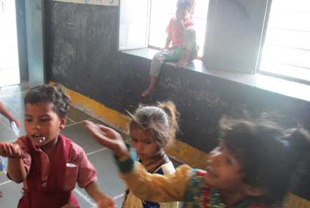 Children at the Child Care project catching bubbles