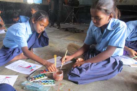 Children at the school learning how to use water colour paints