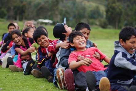 Boys and girls all sitting in a line playing a game 