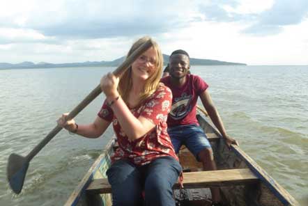 Lady paddling a boat on the sea with man in the back