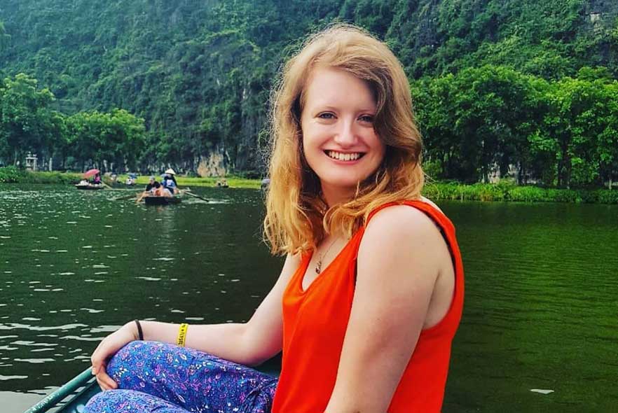 Lady volunteer on a boat on the lake