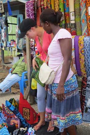Two ladies inspecting goods in the marketplace 