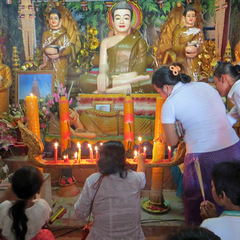 Volunteer lighting candles in temple