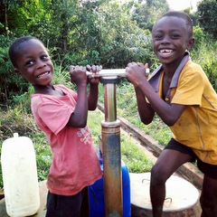 Children using the charity water pump